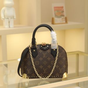 The Alma BB handbag has been reimagined as the newest addition to the Trunk collection, paying homage to the brand's rich heritage of travel with its iconic signature. Crafted from Monogram canvas, it features deep leather trim accented by dazzling metal corners and studs. This version comes with a detachable chain that can be worn with the adjustable shoulder strap or separately.19 x 11 x 22 cm (H x W x L) Monogram coated canvas Cowhide leather trim Fabric lining Metal hardware Zip closure with padlock and key Interior pocket accommodates 6.7-inch smartphone, earphones, Rosalie coin purse, keys, and lipstick Shoulder strap:Removable, adjustable Strap half-length: 50.0 cm Strap half-length adjustable to: 66.0 cm Chain: Removable chain Half-length: 22.0 cm Handles: Double handles